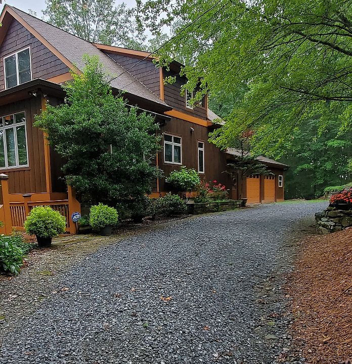 Rear view of home with circular driveway.