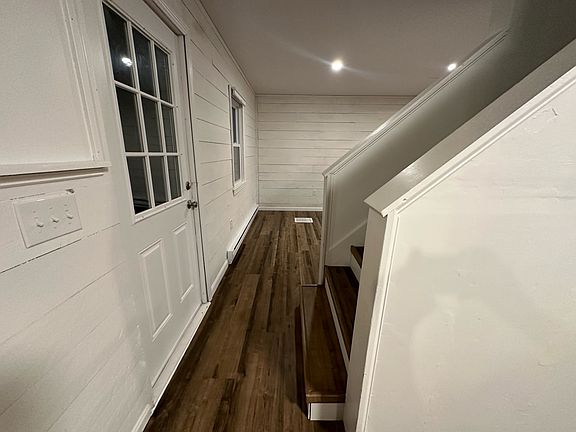 Kitchen to living with porch door and stairs to second floor