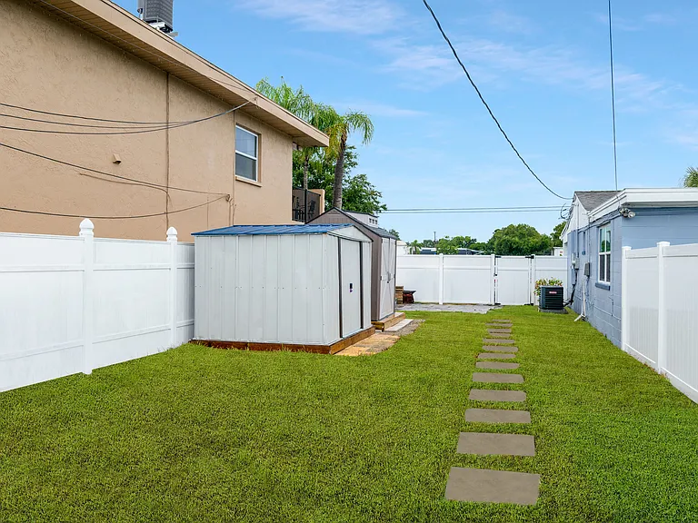 Fenced in Backyard with paved walkway to driveway (2 Parking Spots included)