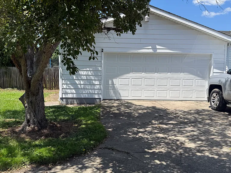 2.5 car garage with garage door opener. Garage door new.