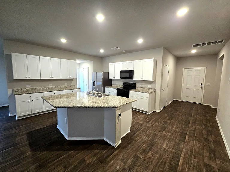 Full kitchen with modern appliances and ample counter space.