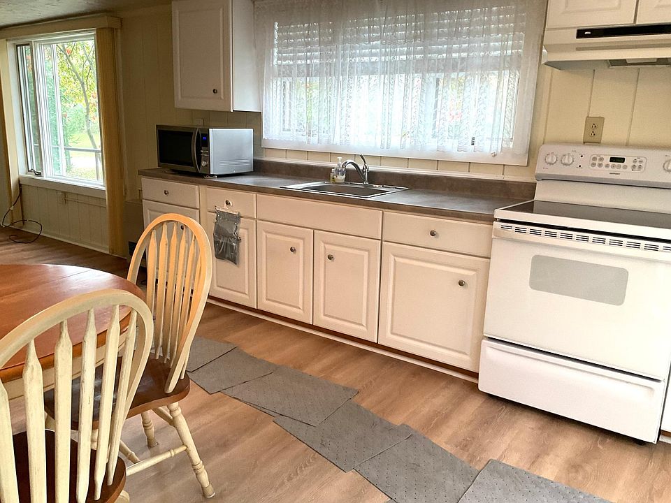 Kitchen, electric stove, microwave, refrigerator.