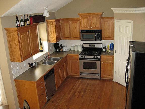 Open kitchen plan with Spacesaver microwve, side-by-side fridge, and pantry.