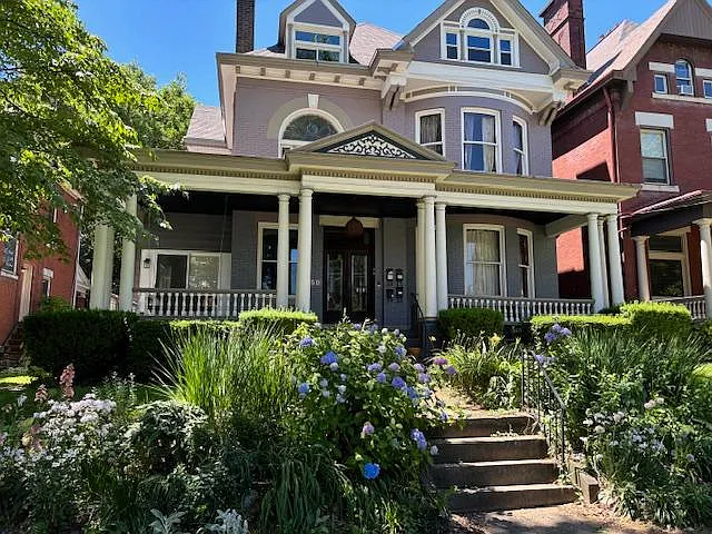 Recent picture of front garden and view of the house from sidewalk.