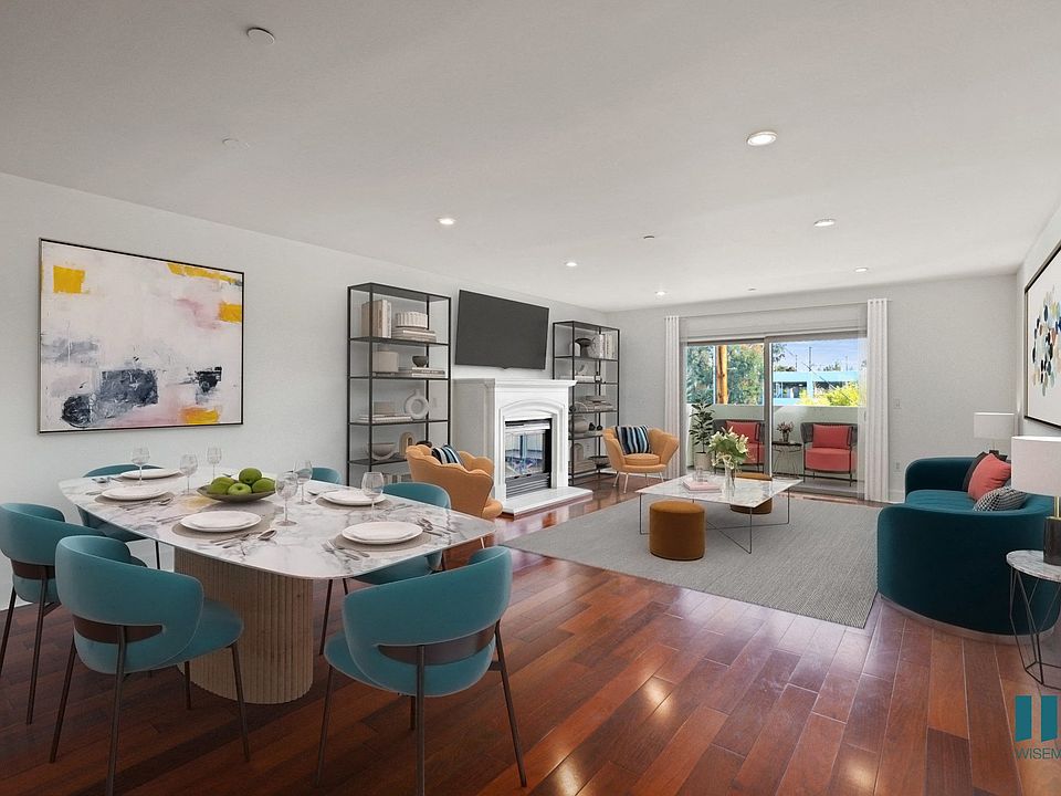 Open-Concept Kitchen, Dining, and Living Room Space with Patio