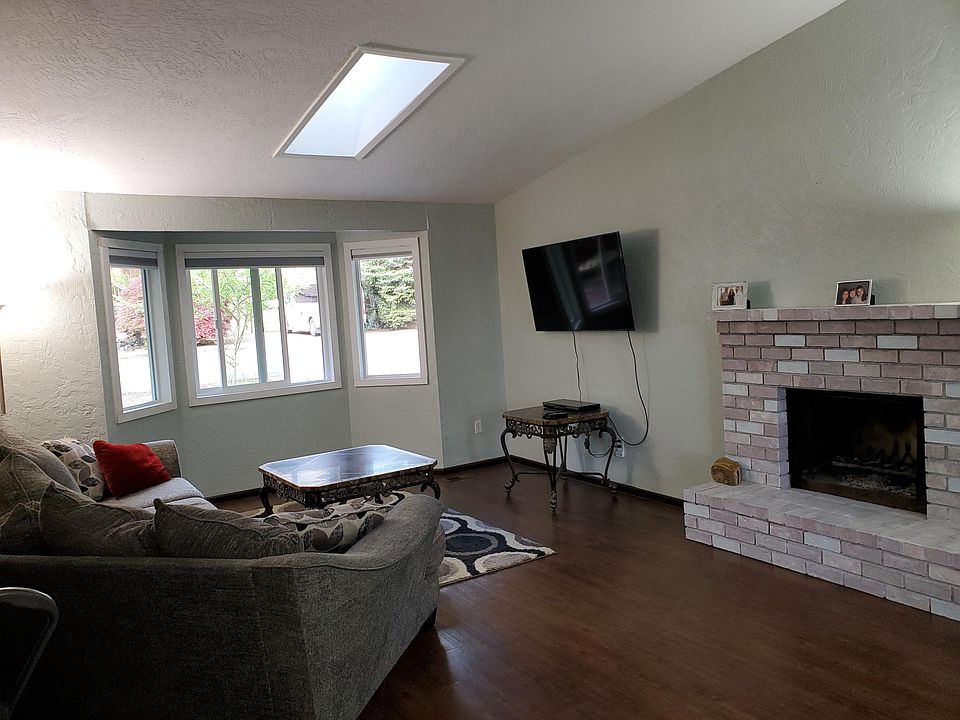 Family room. Three new windows to view the front yard. Brand new paint and white washed fireplace. The fireplace is not operational and a gas insert will be placed there down the road.