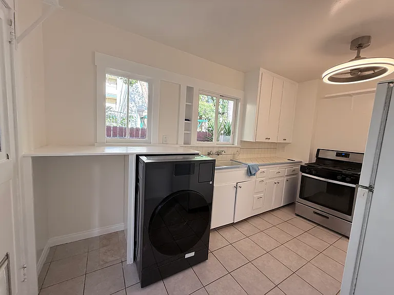 Extra large kitchen with abundance of natural light and room for a table. W/D combo has shelf to fold laundry. Fan/light in kitchen for good air circulation.