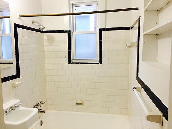 Bathroom with classic black and white tile, built in storage shelves