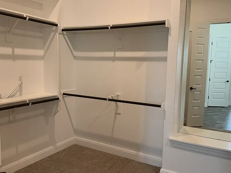 Left side of main bedroom walk-in closet