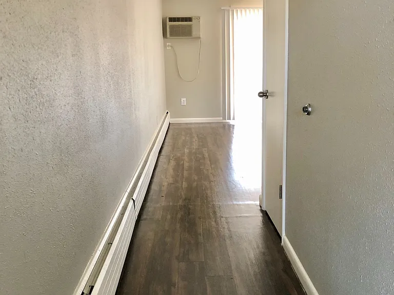 Experience the elegance of a chic hallway with warm wood floors and modern amenities. Experience the elegance of a chic hallway with warm wood floors and modern amenities.