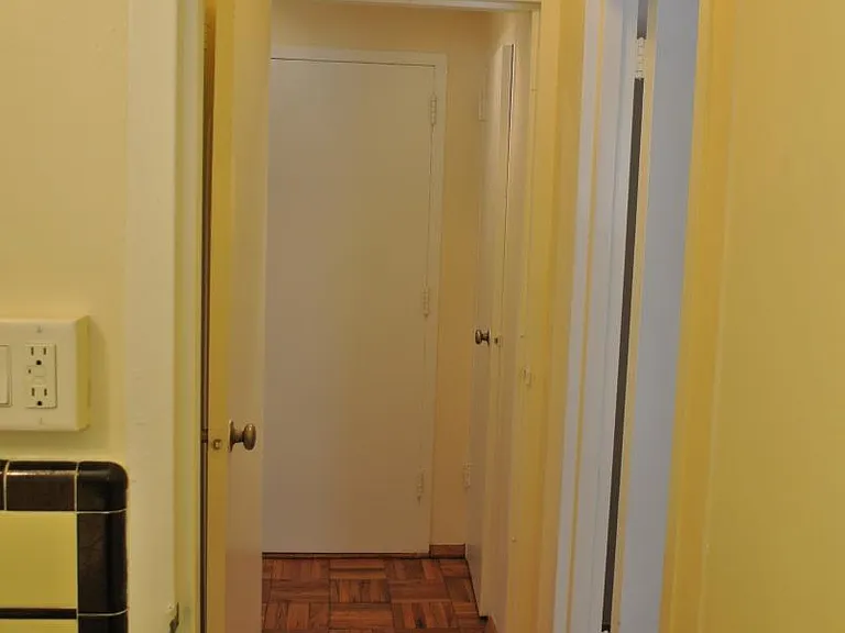 Hallway from bathroom toward bedroom and entrance