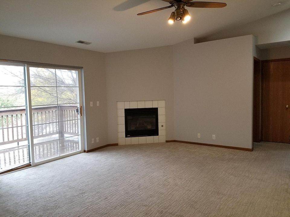 Living room including fireplace and sliding glass door to deck