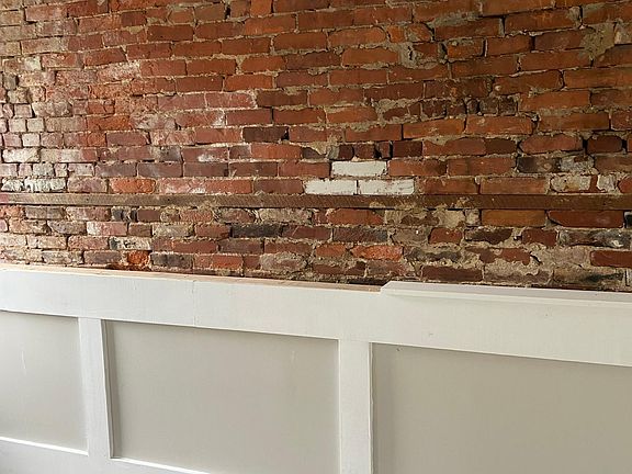 Bedroom w Exposed Brick and detailed wood work