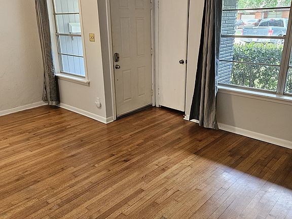 Living room. Entrance is door on left. Closet is door on right. Good natural light.