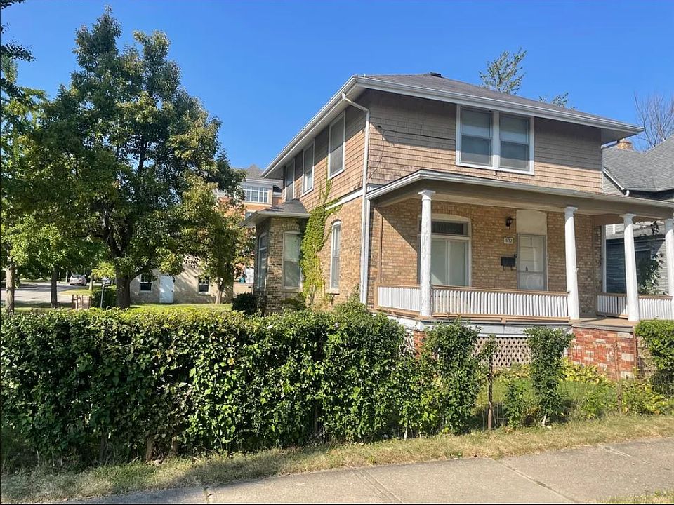 Front brick exterior with a spacious porch