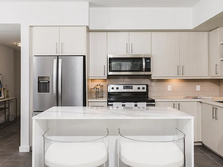 Kitchens with custom cabinetry, bar seating, and built-in shelves