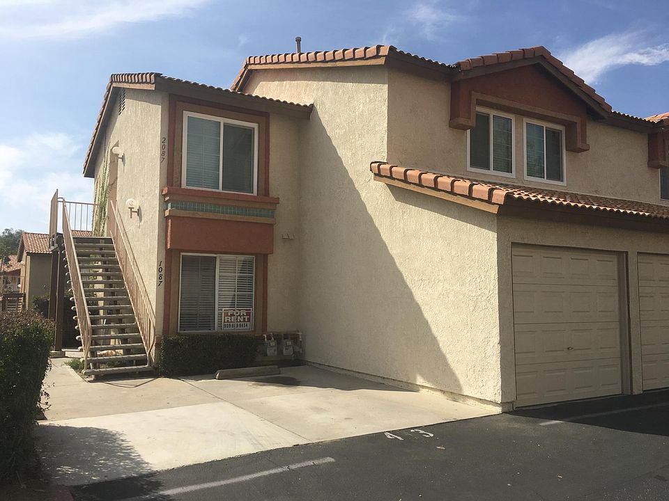 Front outside view of downstairs property, parking space and garage