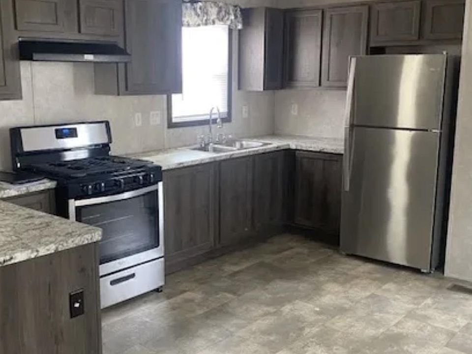 Open kitchen floor plan with stainless steel appliances