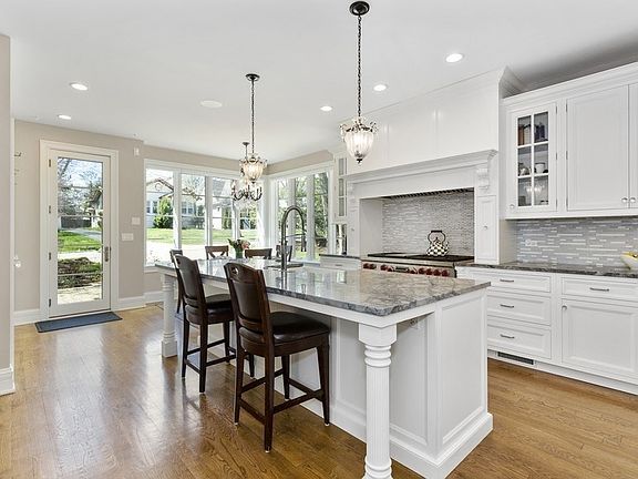 The large cook's kitchen is on trend with quartzite counters, Wolf, Subzero, and custom island.