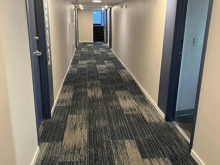 Hallway of our split level building with 15 large studio apartments and a laundry room