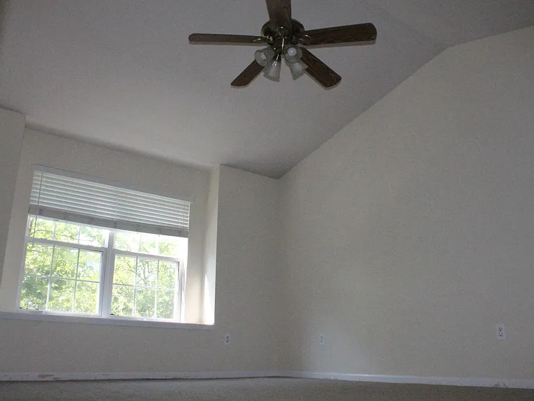 master bedroom with cathedral ceilings with remote control c