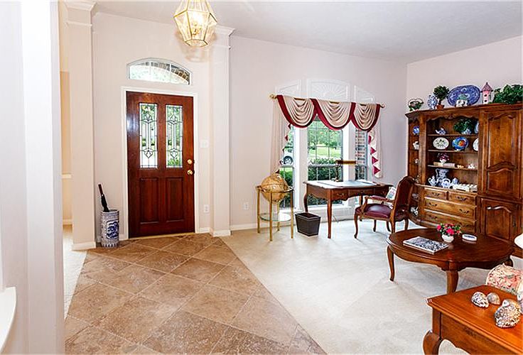 Beautiful Entry with travertine tile and the Formal Living Room in the view