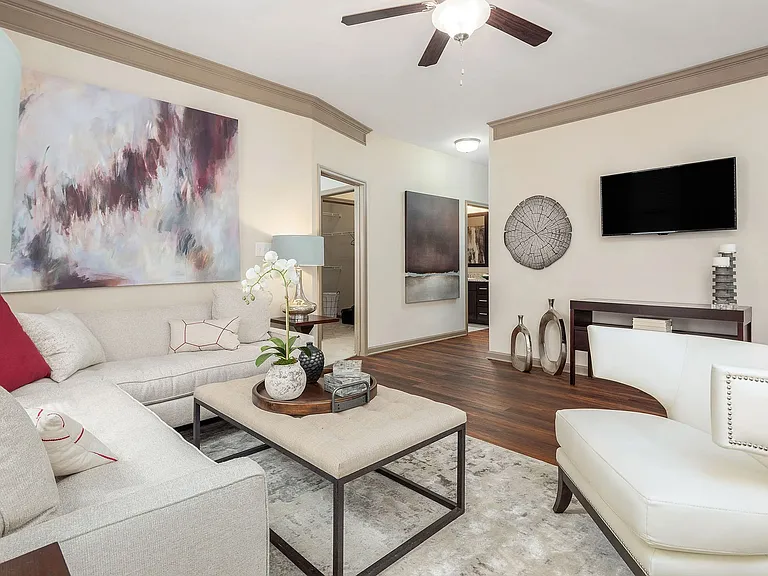 Spacious open-concept living room with modern finishes, crown molding, and stylish designelevated apartment living in Charlotte.