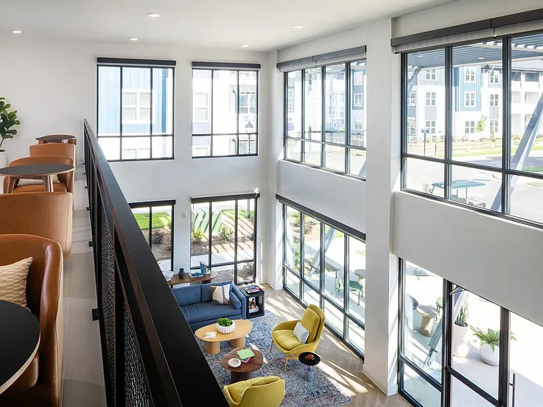 Two-level clubhouse with multiple lounge spaces and private seating