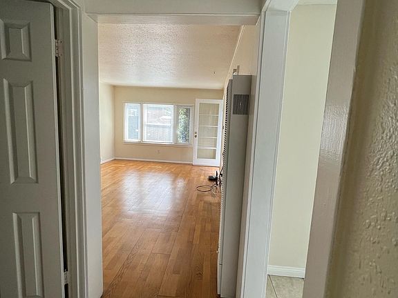 hallway pick from bedroom - bathroom door on left - entrance to kitchen on right