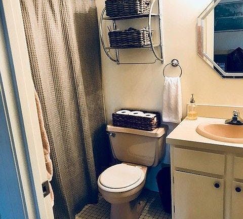 Bathroom has a tub and shower.