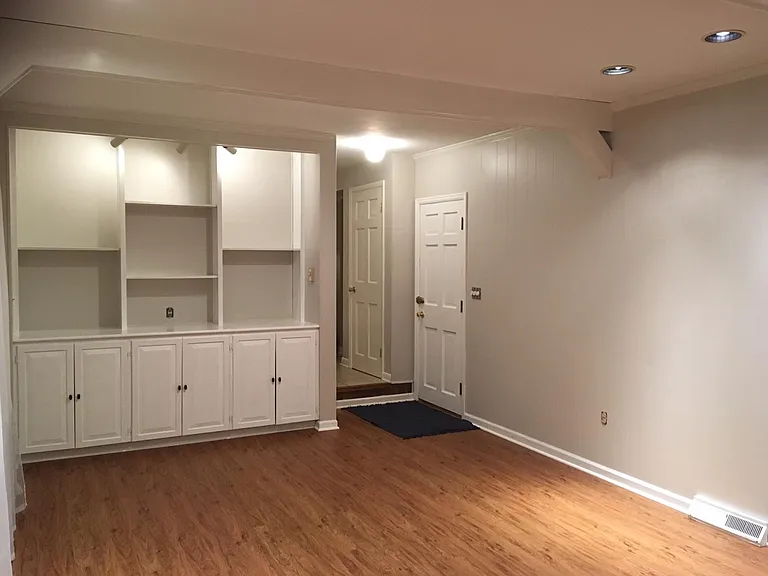 Family room looking past garage and basement doors.