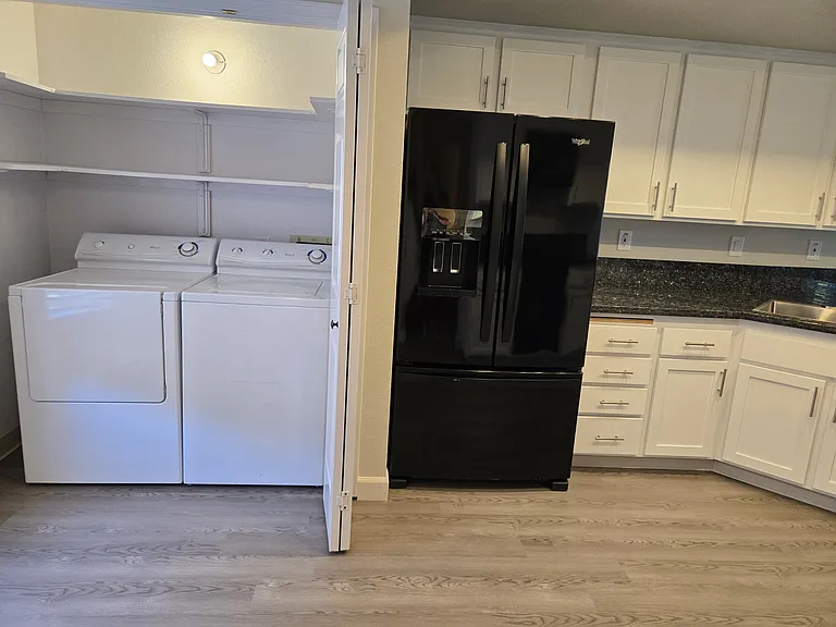 Full-size washer and dryer included, with convenient indoor laundry and extra shelving for storage.