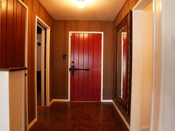 Entry hall with redwood block flooring and old growth redwood panel walls