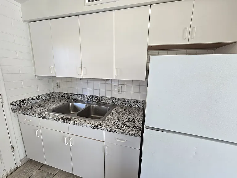 Clean Kitchen with Granite Counter Top and Island.