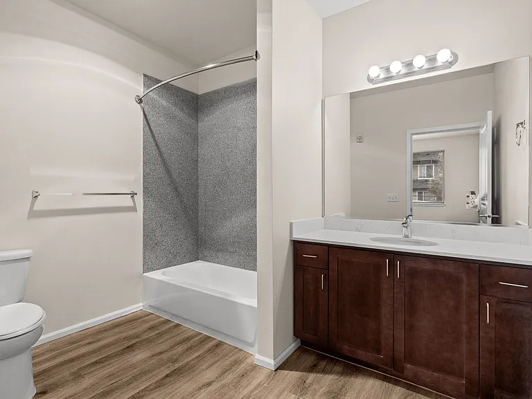 A clean, modern bathroom featuring a spacious vanity and tub-shower combo. A clean, modern bathroom featuring a spacious vanity and tub-shower combo.