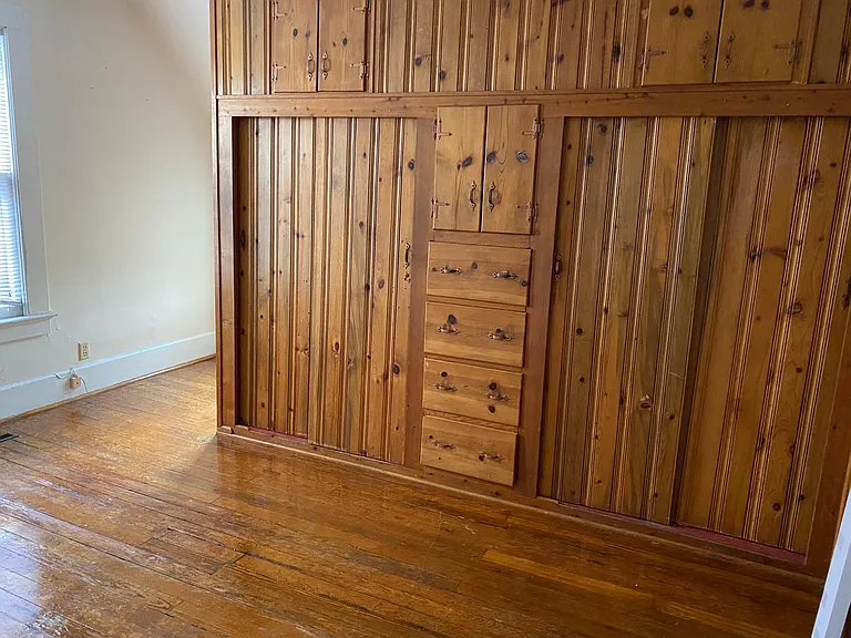 Middle upstairs bedroom. Look, more built-in drawers and double closets. Ceiling fan. hardwood floor