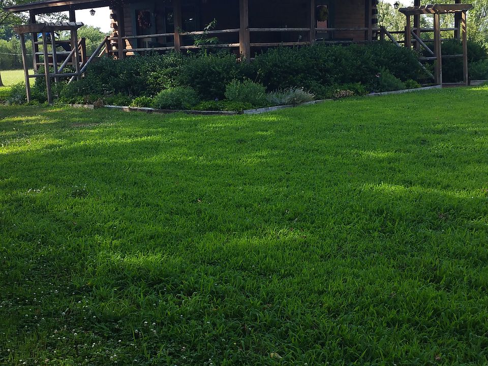Log cabin with 12 ft. wraparound covered porch on 2 sides.