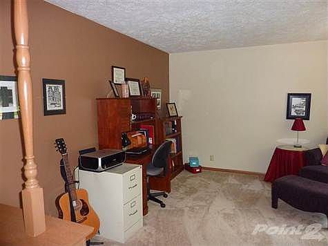 Living room is spacious and has provided nice office space for this family.