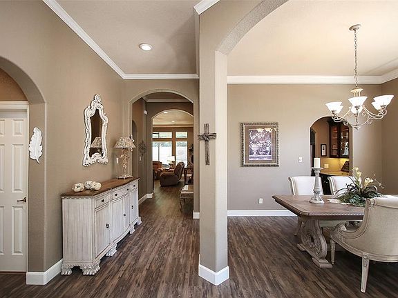 The entryway opens up into the formal dining room and features high-quality laminate flooring throughout, extending into the family room. Crown molding accents the high ceilings and 4-inch baseboards add the finishing touch.
