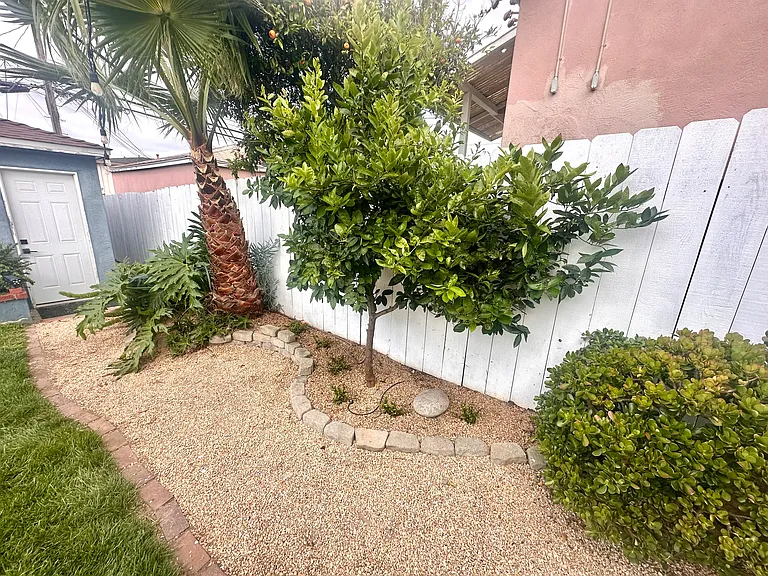Backyard trail to garage with lighting for safety