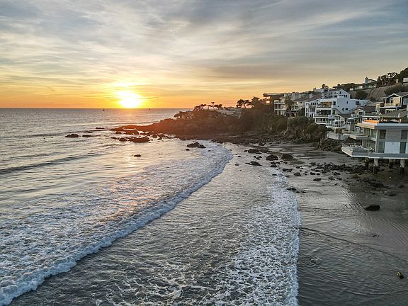 Watch the sun melt into the horizon with waves whispering below.