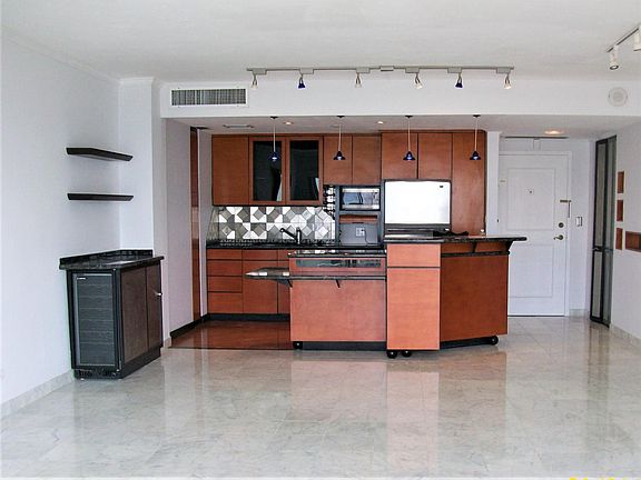 Open kitchen to living area. Marble flooring.