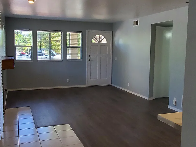 Front door entrance from the back door. Shows hallway to Bedroom2 and 2nd Bathroom
All windows and 3 of 4 doors have wood-look white blinds