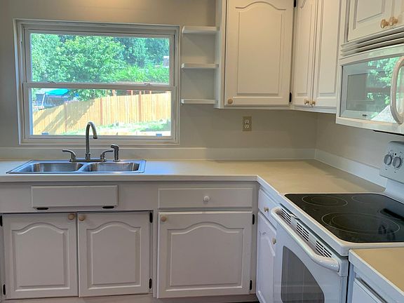 Updated white kitchen with pull-out shelves
