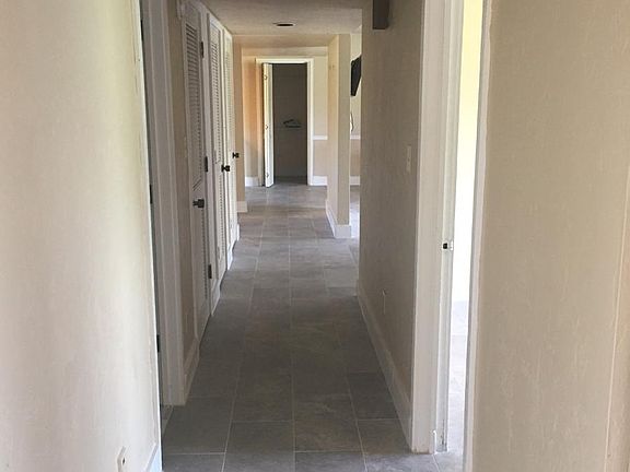 The entire unit, including the hallway, has been tiled with