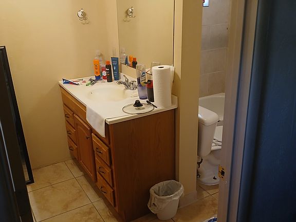 Bathroom vanity and closet are in one part of bathroom, shower and toilet are right next to each other