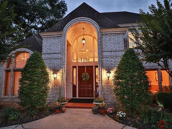 Newly refinished, solid wood front door & flanking windows create a beautiful entrance into the grand foyer of this unique custom built home.