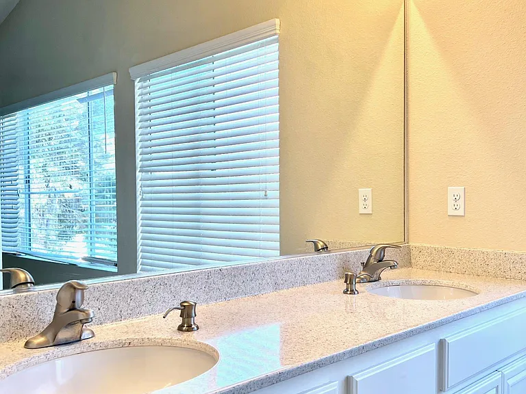 Large primary bedroom with vaulted ceilings and plenty of natural morning light.