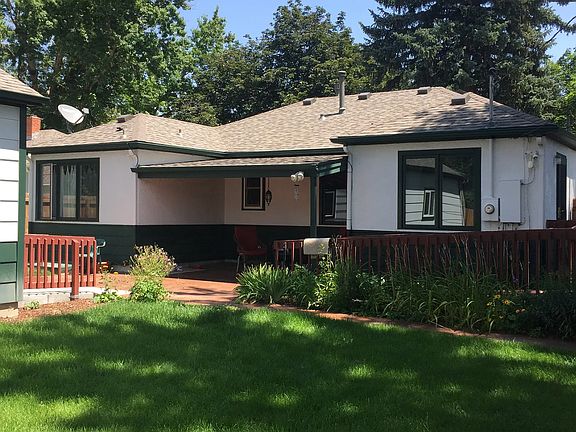 Backyard with garage to left and outdoor patio off kitchen.