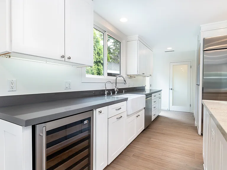 Kitchen and wine cellar. Door to third bathroom on the back.